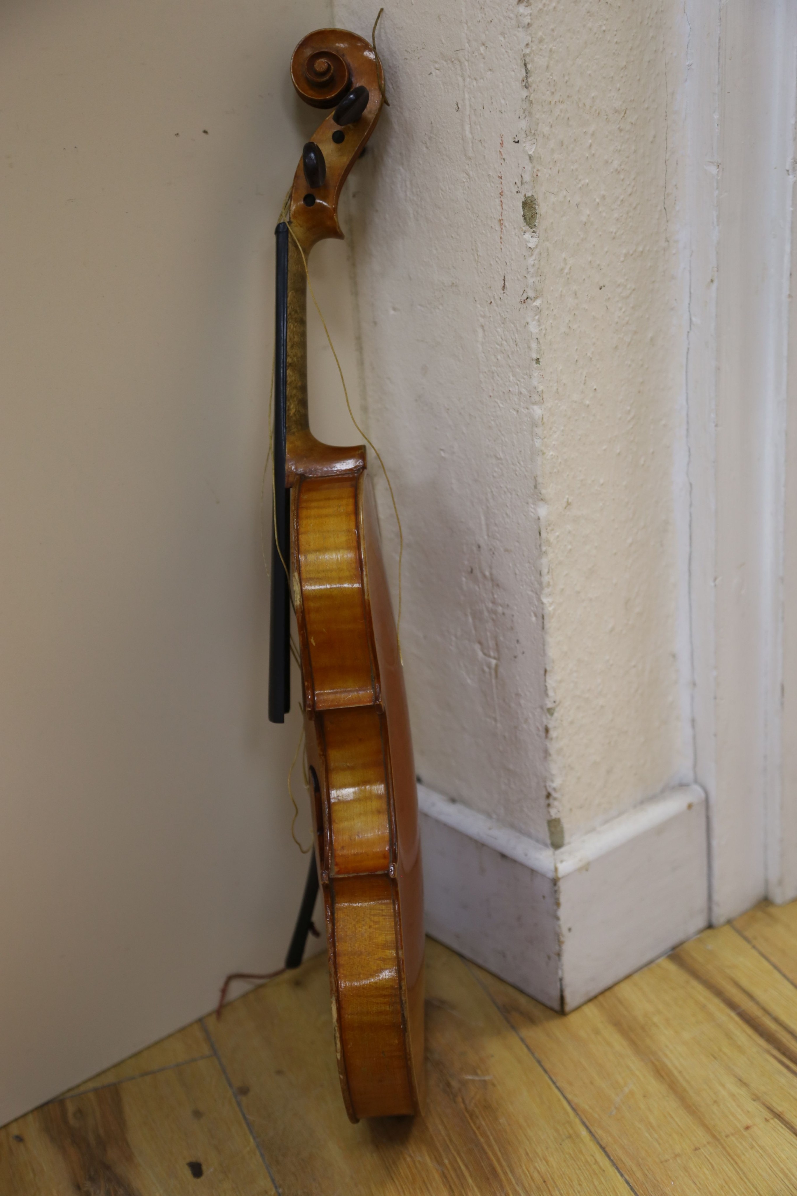 A Stradivarius copy violin and two bows and another bow, both cased, backs 33cm and 30cm